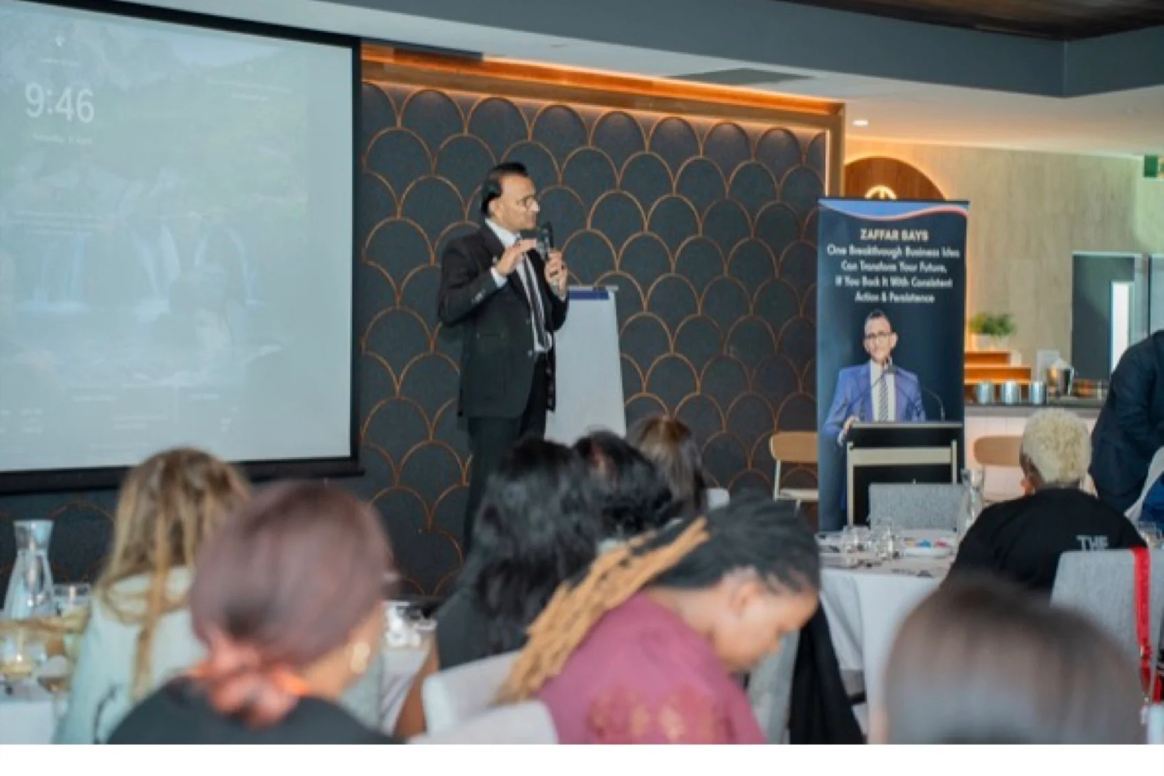 A full room of attendees watching a Zaffarology session