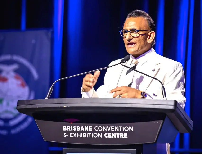 Zaffar Khan speaking on stage at the Brisbane Convention & Exhibition Centre